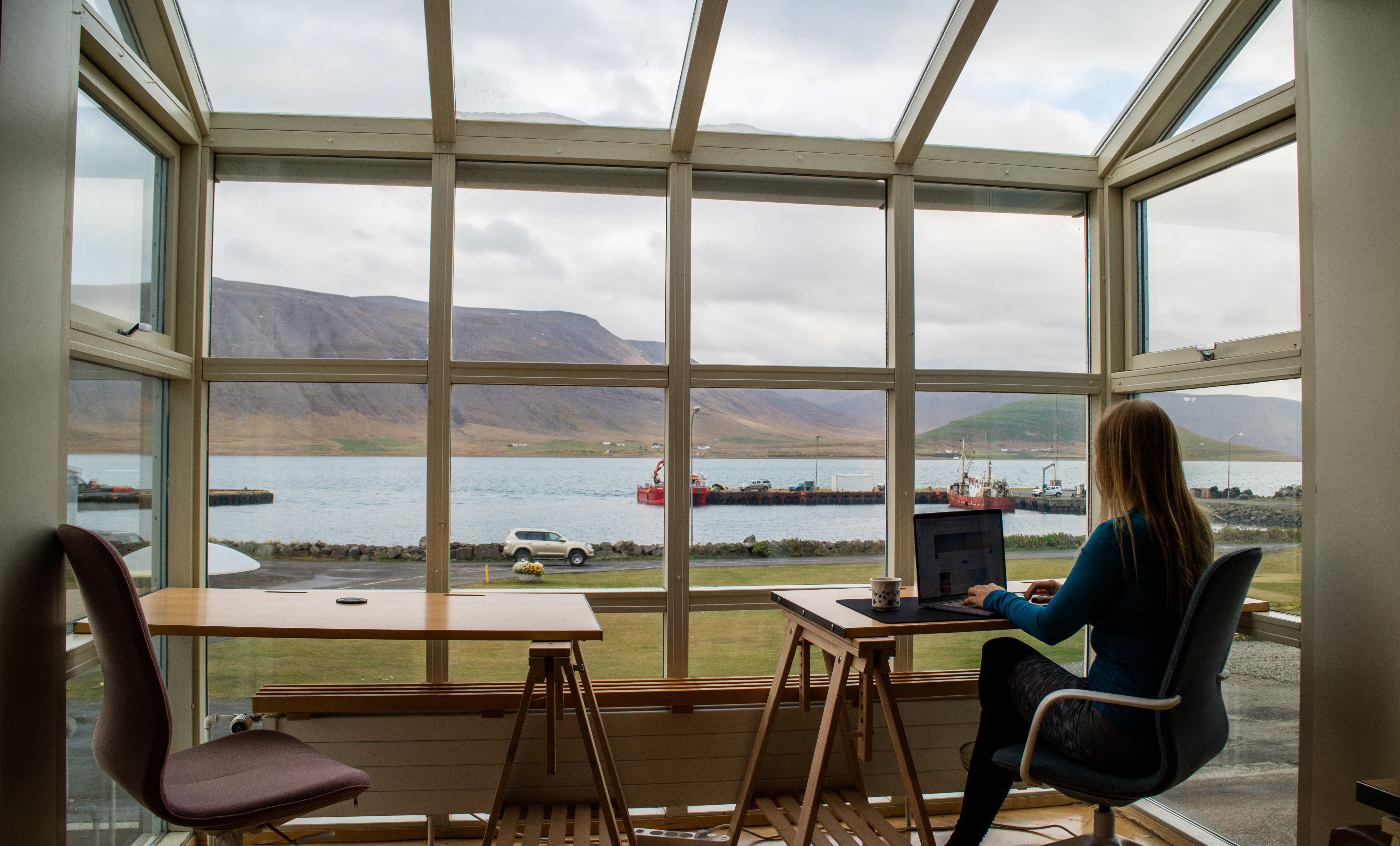 Woman working in front of a big window