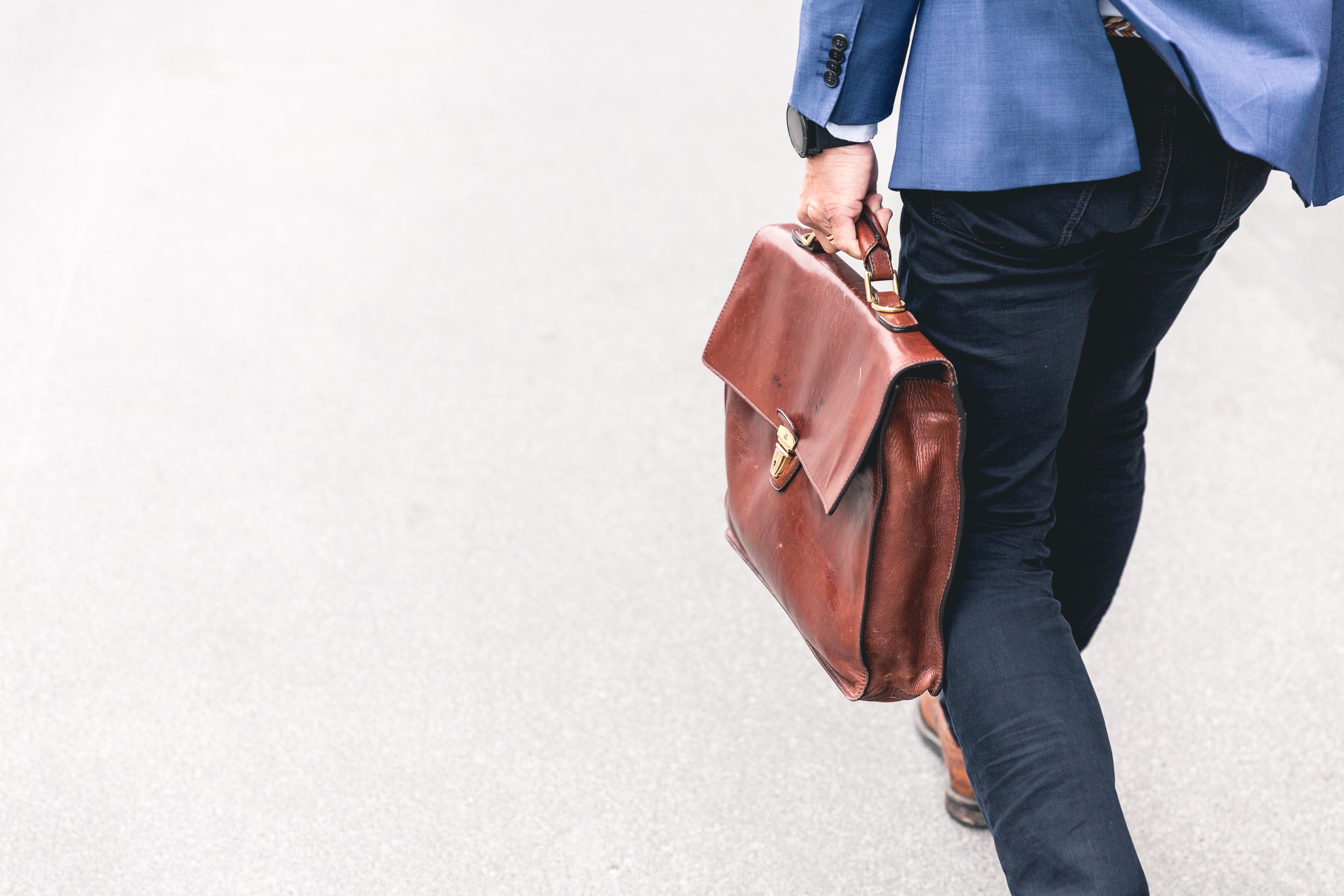 Man walking with a leather briefcase.
