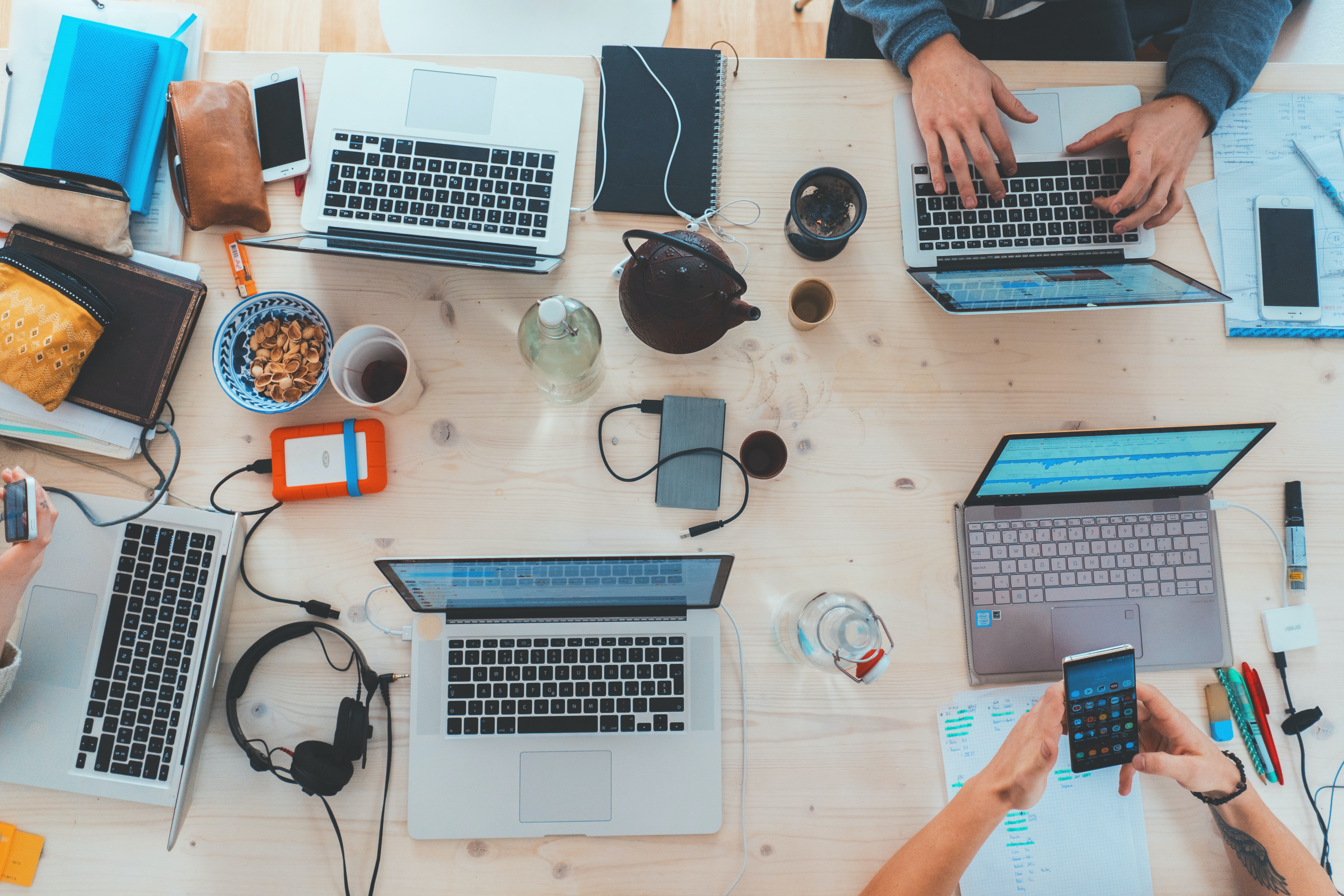 Various laptops on a co-working table.
